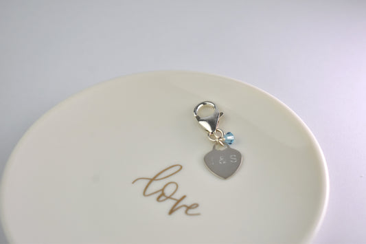 Sterling silver engraved heart and trigger clap with a tiny blue crystal. Something blue charm for a bouquet, shoe, garter or inside the gown