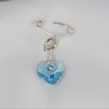 Sterling silver secret something blue pin. With a pretty blue crystal heart.  To be worn on your gown or tied with the ribbon supplied to your bouquet.
