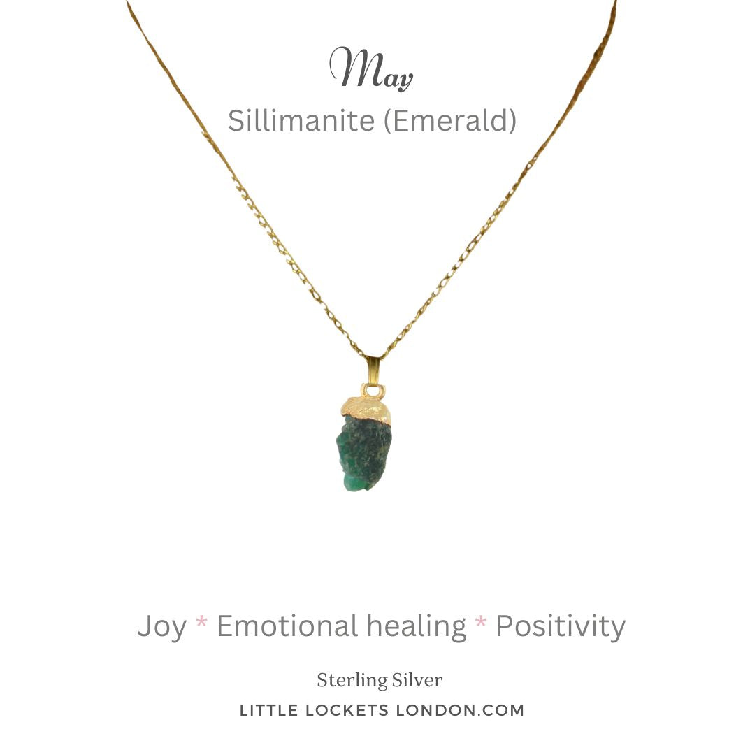 Sillimanite is a clear crystal that has been dyed to represent the emerald. It is not possible to find raw crystal emeralds. The pendant has a gold plated sterling silver tip and is suspended from a sterling silver gold plated chain. It is mounted on card with the birth month of May - repreenting the emerald - and the gemstone name and three of the properties of sillimanite - joy - emotional healing and positivity