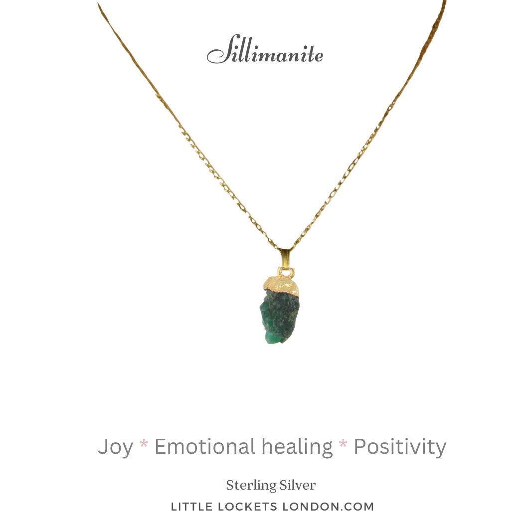 Sillimanite is a clear crystal that has been dyed to represent the emerald. It is not possible to find raw crystal emeralds. The pendant has a gold plated sterling silver tip and is suspended from a sterling silver gold plated chain. It is mounted on card with the gemstone name and three of the properties of sillimanite - joy - emotional healing and positivity