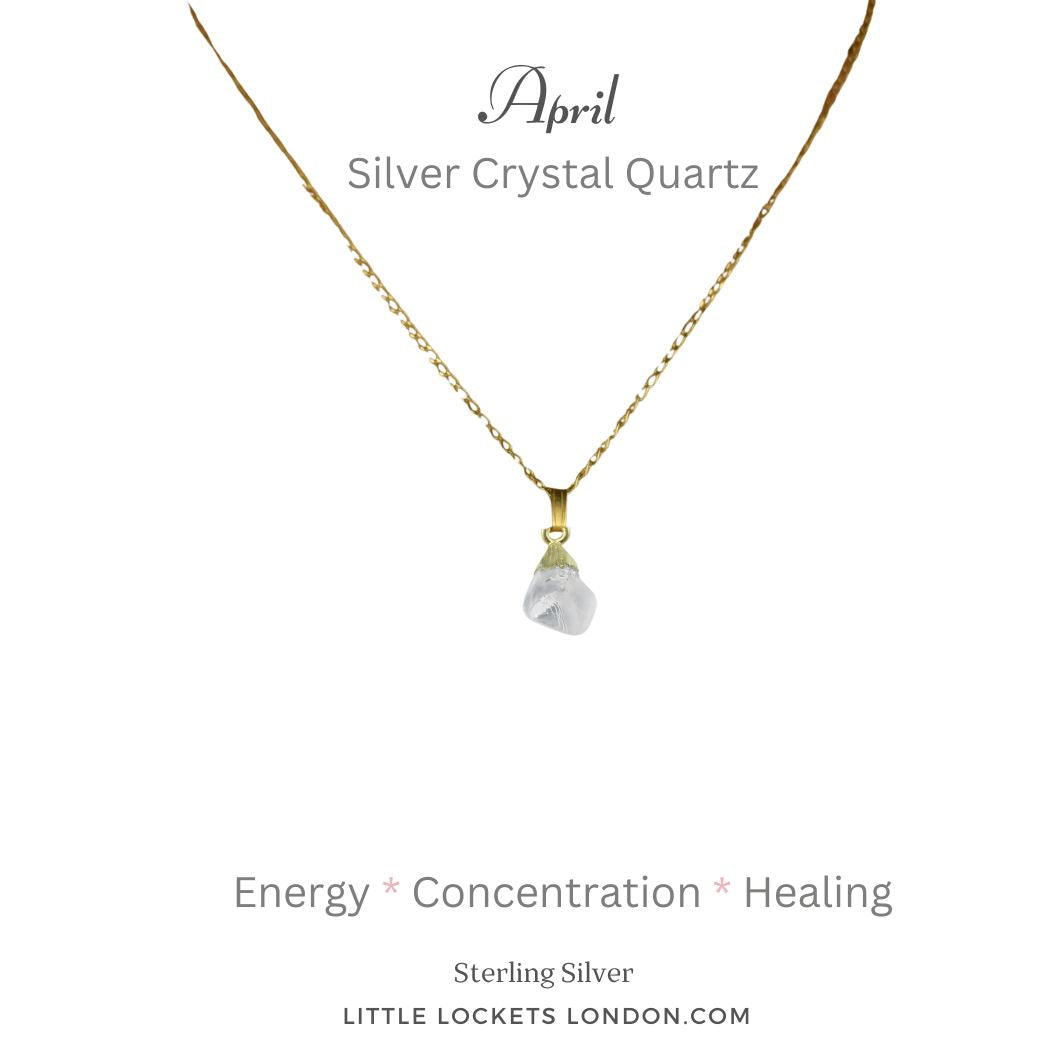 Silver crystal quartz raw gemstone with gold plated sterling silver tip suspended from a gold plated sterling silver chain. The pendant is mounted on card with the birth month and name of the gem and three of its qualities - energy concentration healing