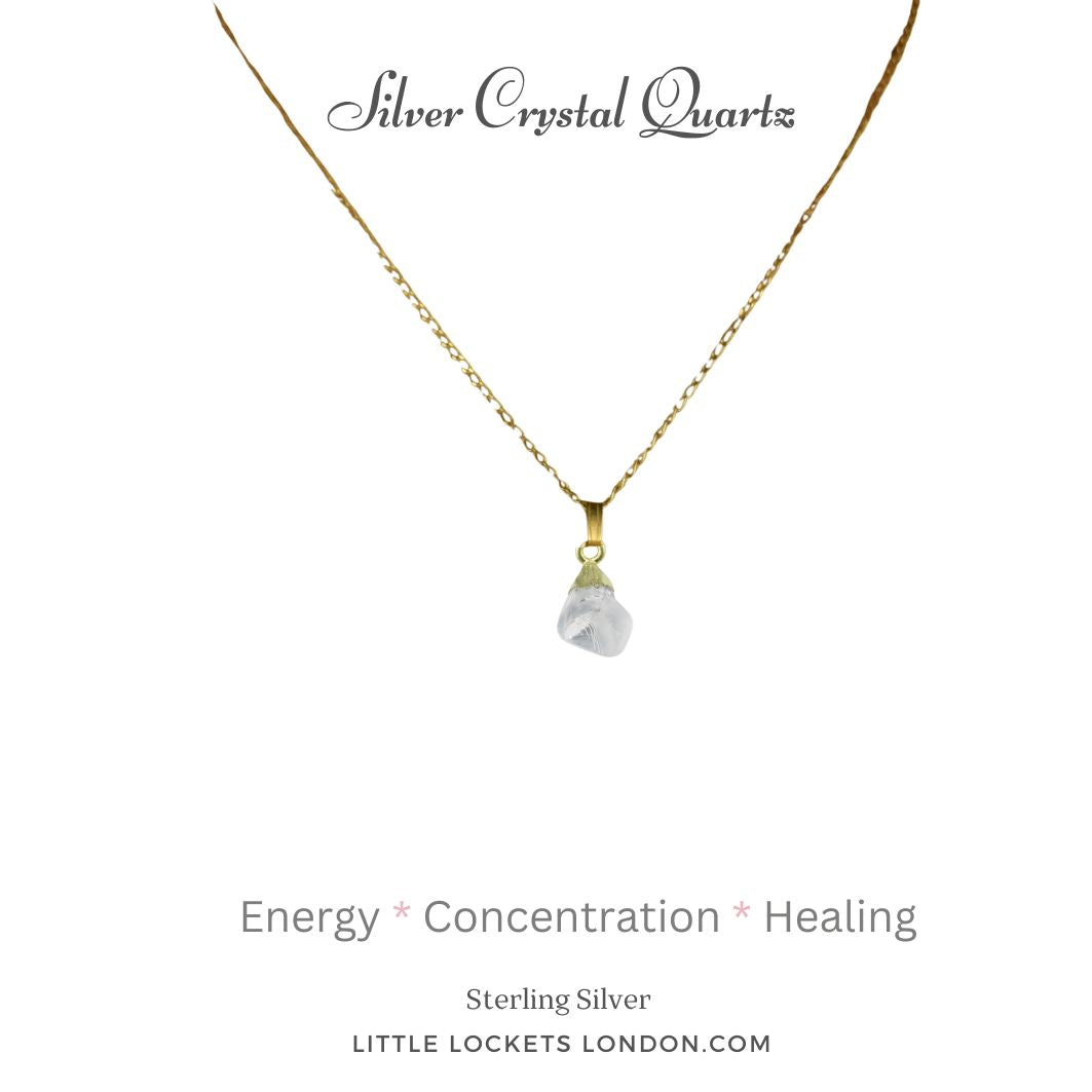 Silver crystal quartz raw gemstone with gold plated sterling silver tip suspended from a gold plated sterling silver chain. The pendant is mounted on card with the name of the gem and three of its qualities - energy concentration healing