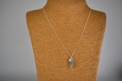 raw crystal moonstone pendant  shown with sterling silver tip and suspended from a sterling silver chain.