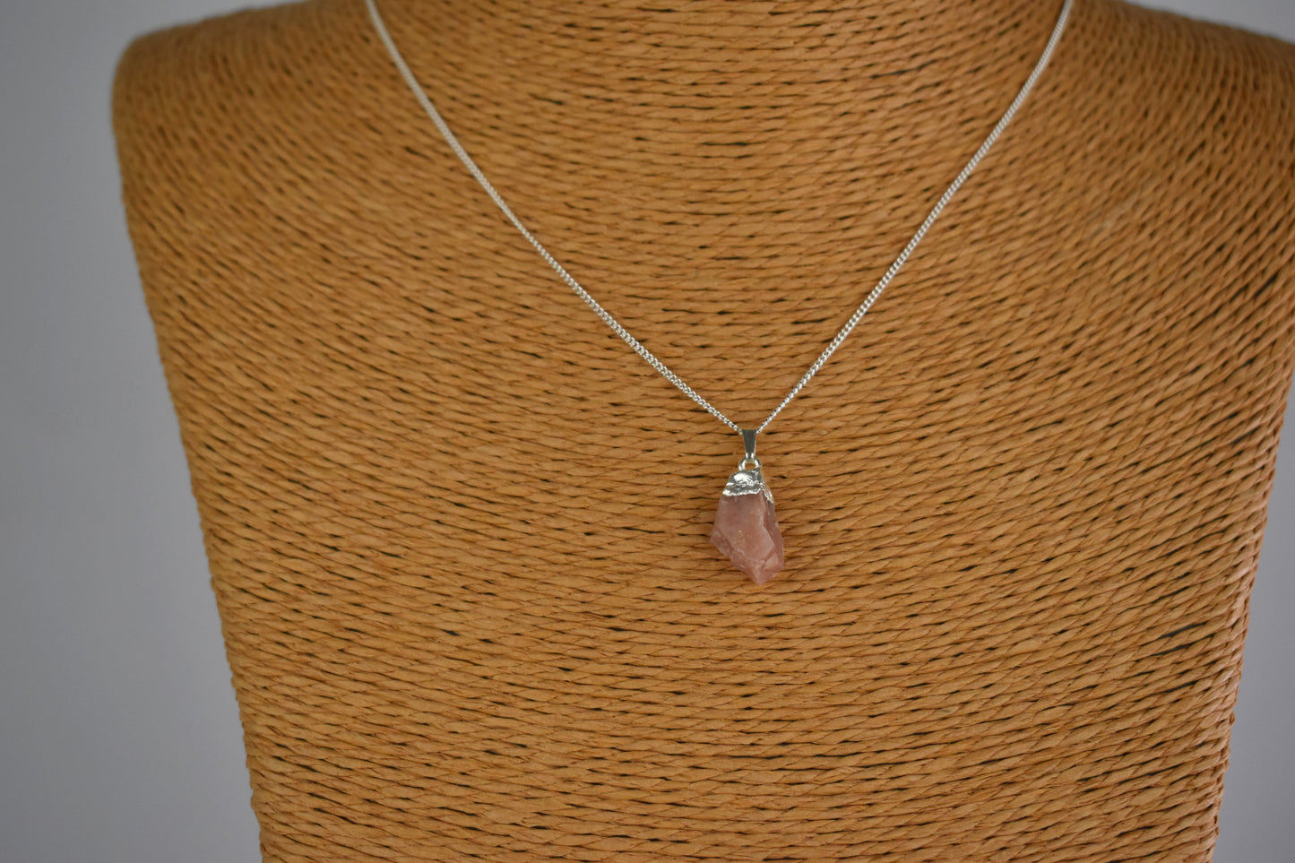 pink opal raw gemstone with sterling silver tip and mounted on a sterling silver chain