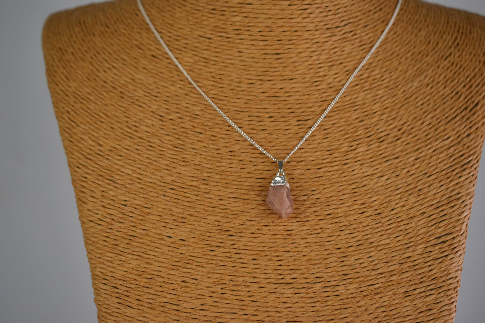 pink opal raw gemstone with sterling silver tip and mounted on a sterling silver chain