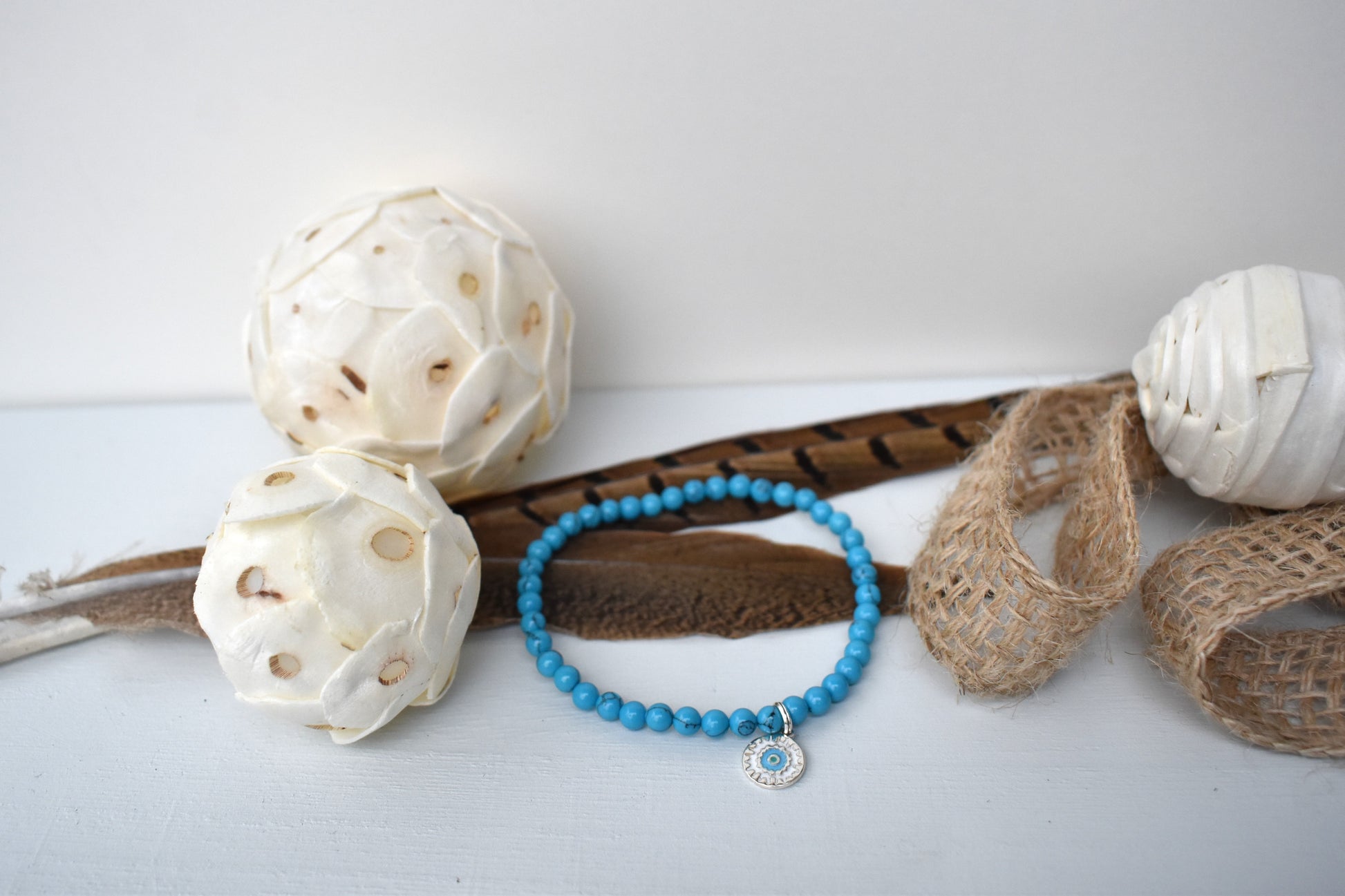 Elasticated bracelet with 4mm reconstituted turquoise beads and a perfect sterling silver mandala charm, make the perfect beach bracelet.