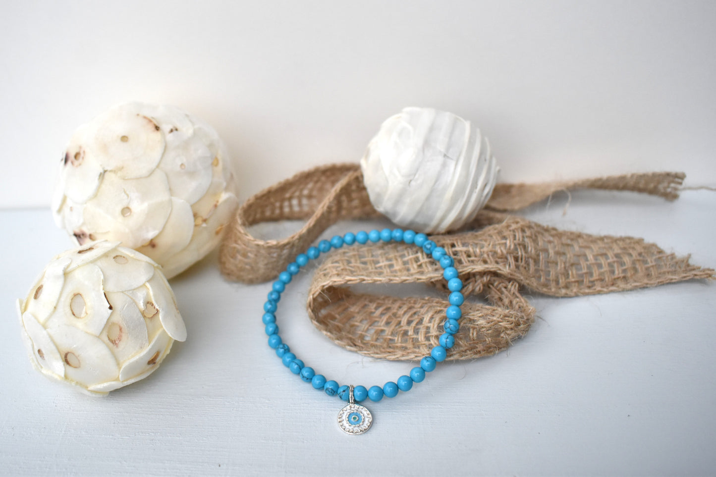 Elasticated bracelet with 4mm reconstituted turquoise beads and a perfect sterling silver mandala charm, make the perfect beach bracelet.