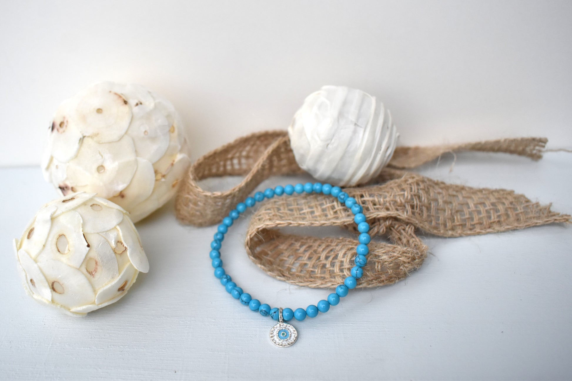 Elasticated bracelet with 4mm reconstituted turquoise beads and a perfect sterling silver mandala charm, make the perfect beach bracelet.