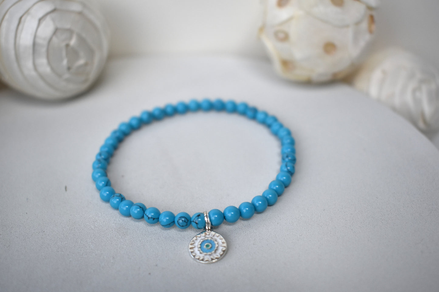 Turquoise beaded bracelet with sterling silver mandala charm