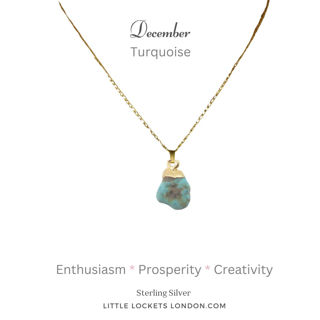 Turquoise raw crystal with sterling silver gold plated tip suspended from a gold plated sterling silver chain. The pendant is mounted on card with the birthstone month of December and the gemstone's name plus three of its properties - enthusiasm, prosperity and creativity