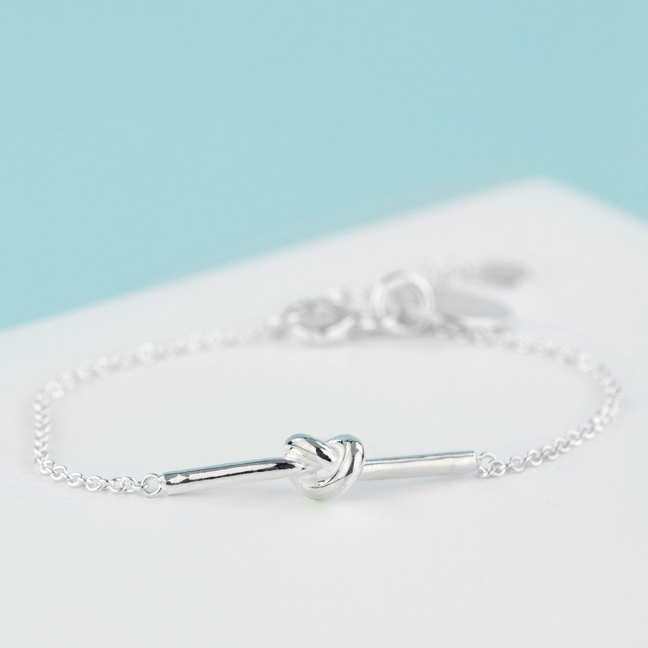 sterling silver bracelet with silver bar tied in knot finished with silver chain and sterling silver engraved disc with name or date of your choice. The 20mm extension chain ensures it fits all wrists