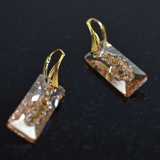 Highest quality Austrian crystal earrings shown in Golden Shadow,.  The centre of the crystal  is designed to look as if the crystal is still growing and catches the light beaufifully. Suspended from gold plated sterling silver lever back wires and gift boxes.