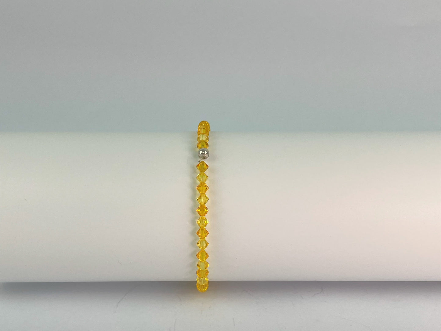 sunshine yellow crystal elasticated bracelet finished with a small silver bead
