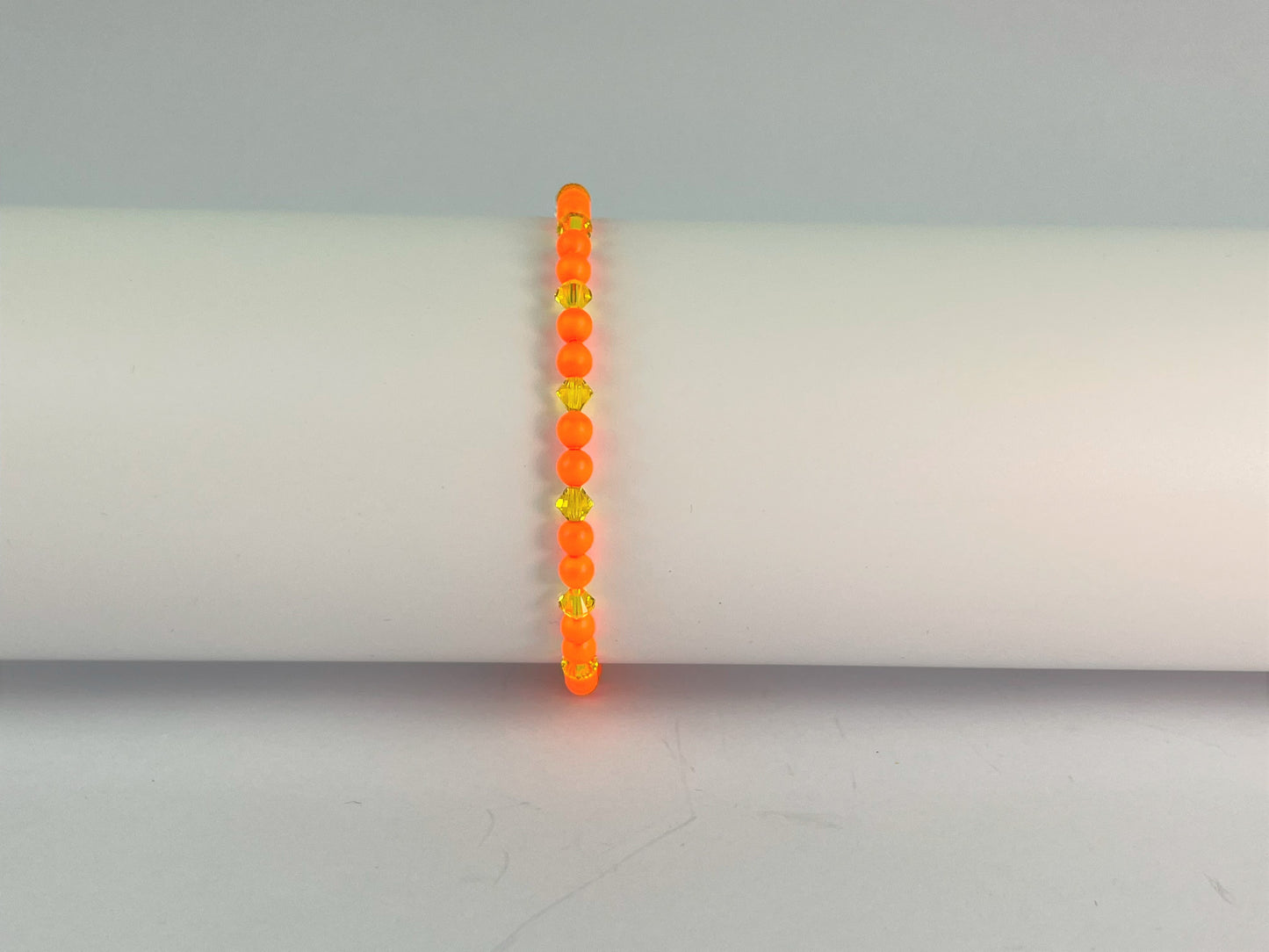 neon orange beads teamed with sunshine yellow crystals for this cute elasticated bracelet