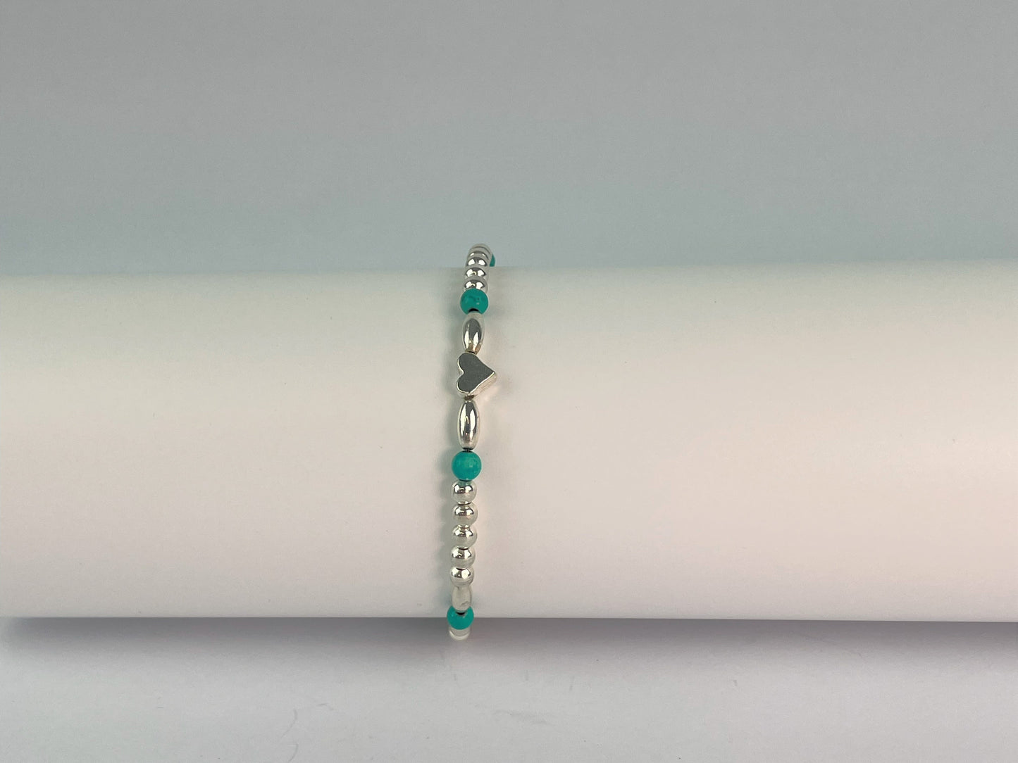 fancy beaded turquoise and silver plate elasticated bracelet with silver heart centre