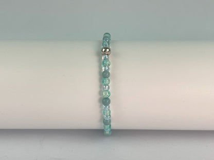 turquoise glass and green beads make up this elasticated bracelet