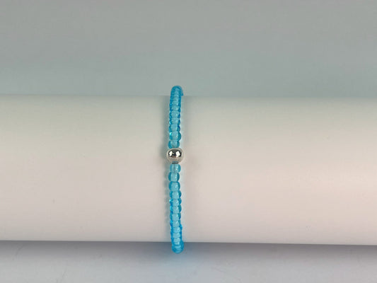 Bright blue glass beads make up this strong elasticated bracelet finished with a silver plated bead