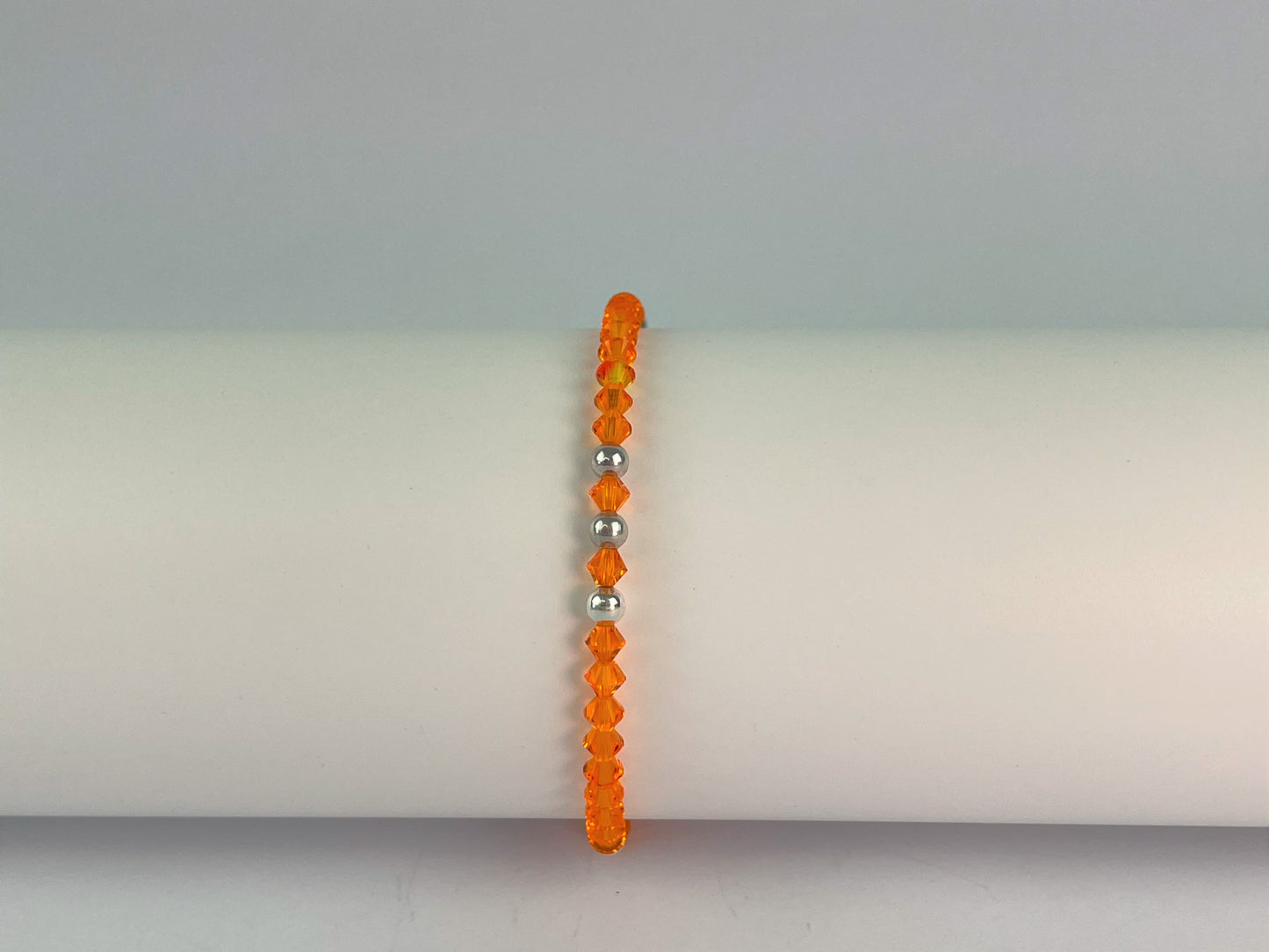 brilliant orange crystals teamed with silver beads for this elasticated bracelet