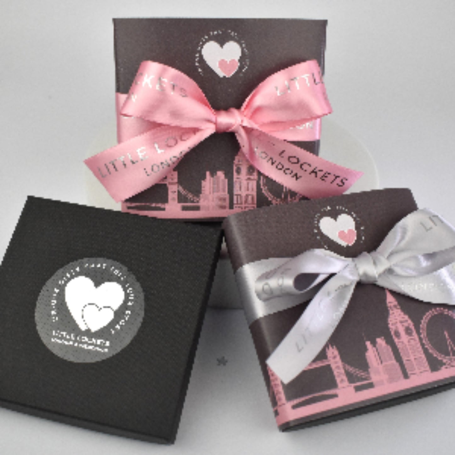 Little Lockets gift wrap options. In branded gift box, or with a London skyline wrap and hand tied pink or grey branded ribbon.