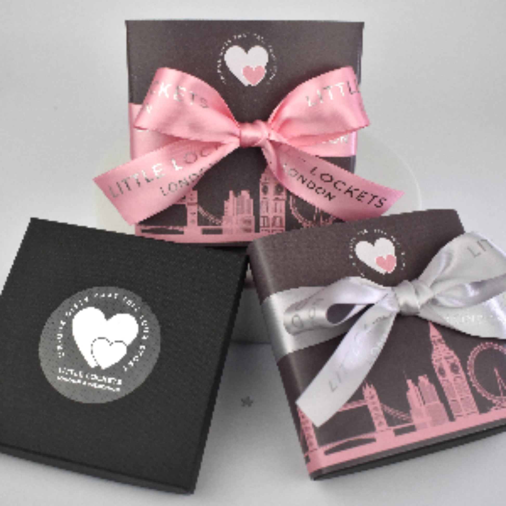 Little Lockets gift wrap options. In branded gift box, or with a London skyline wrap and hand tied pink or grey branded ribbon.