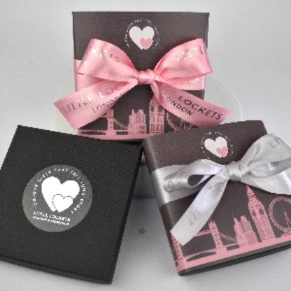Little Lockets gift wrap options. In branded gift box, or with a London skyline wrap and hand tied pink or grey branded ribbon.