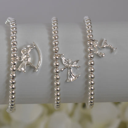 Three silver beaded bracelets - rocking horse, fairy angel and stork