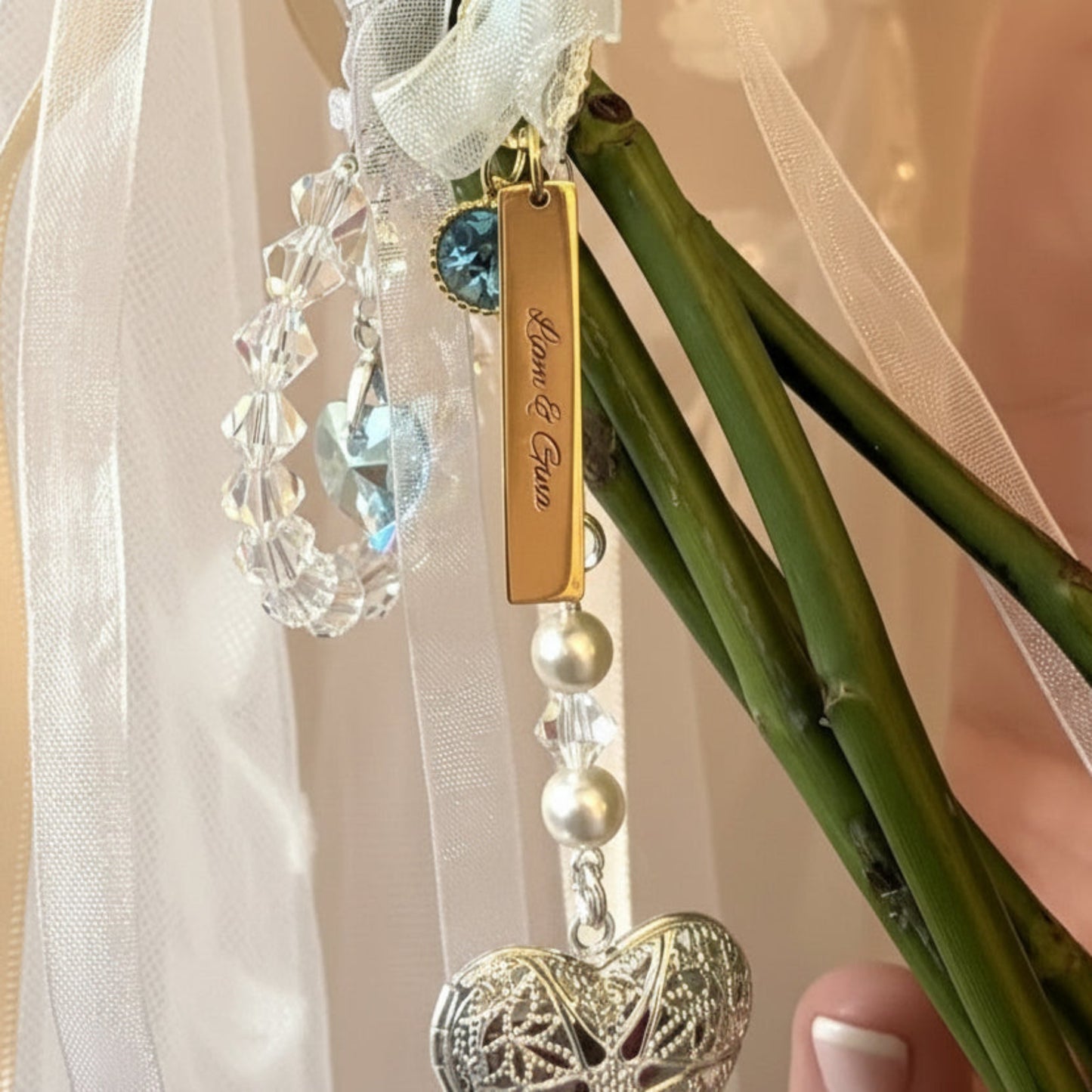  A circle of blue crystals surround a blue crystal heart - shown on a customer's bouquet