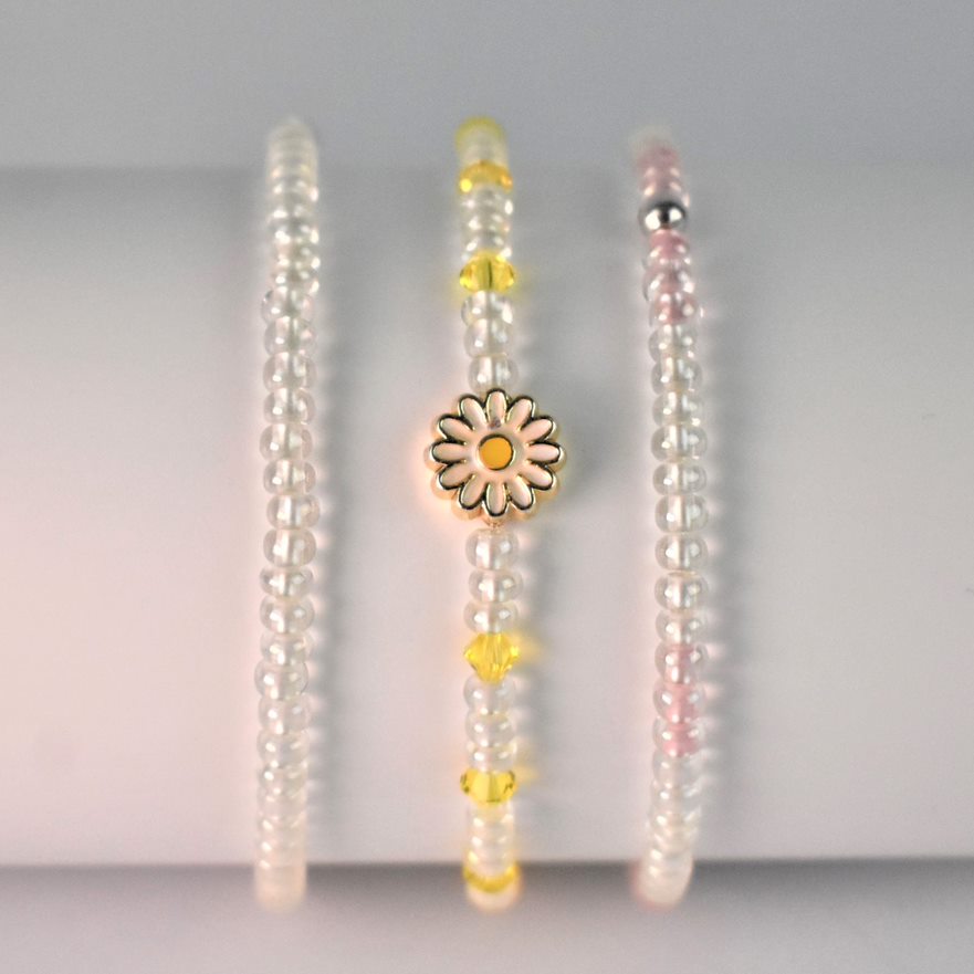 Glass bead elasticated bracelet shown with our daisy bracelet and pink and glass bracelet