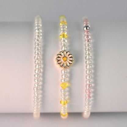 Daisy stacker collection, clear glass bead elasticated bracelet, with daisy white and yellow elasticated bracelet and clear glass and pink elasticated bracelet