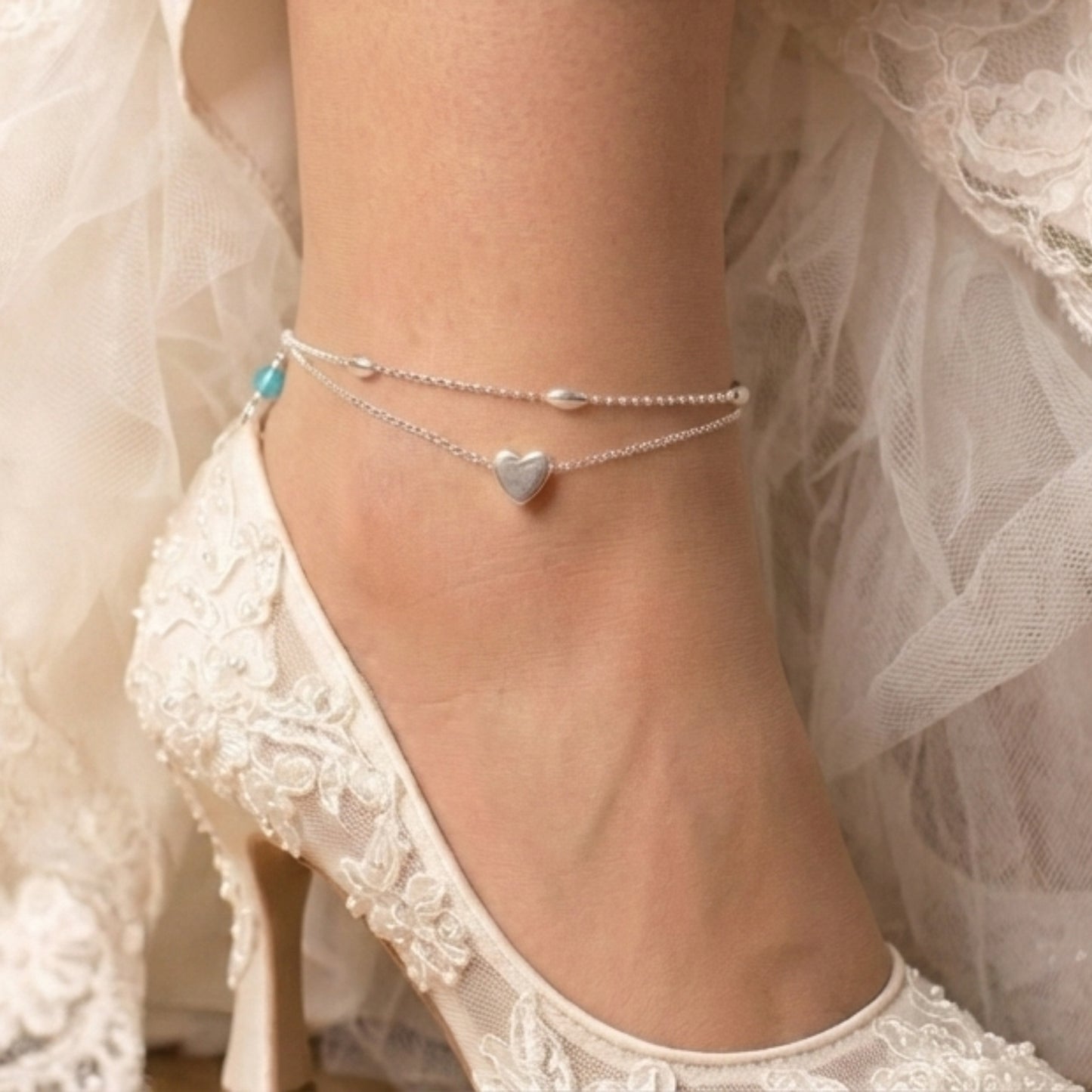sterling silver double strand beaded anklet with heart centre. Added near the fastening is a tiny blue crystal  bead to serve as a bride's "something blue"