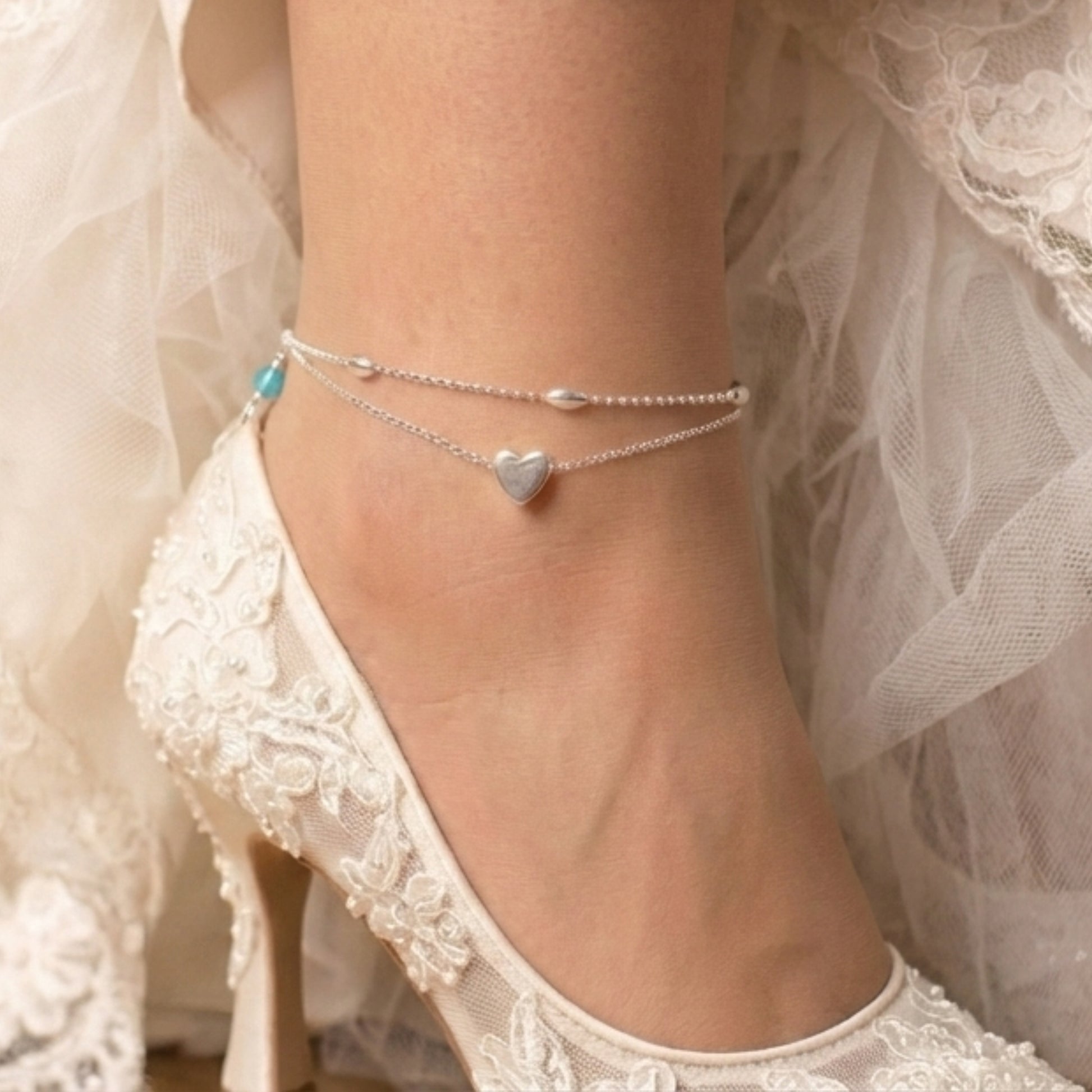 sterling silver double strand beaded anklet with heart centre. Added near the fastening is a tiny blue crystal  bead to serve as a bride's "something blue"