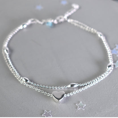 sterling silver double strand beaded anklet with heart centre. Added near the fastening is an optional tiny blue crystal to serve as a bride's "something blue"