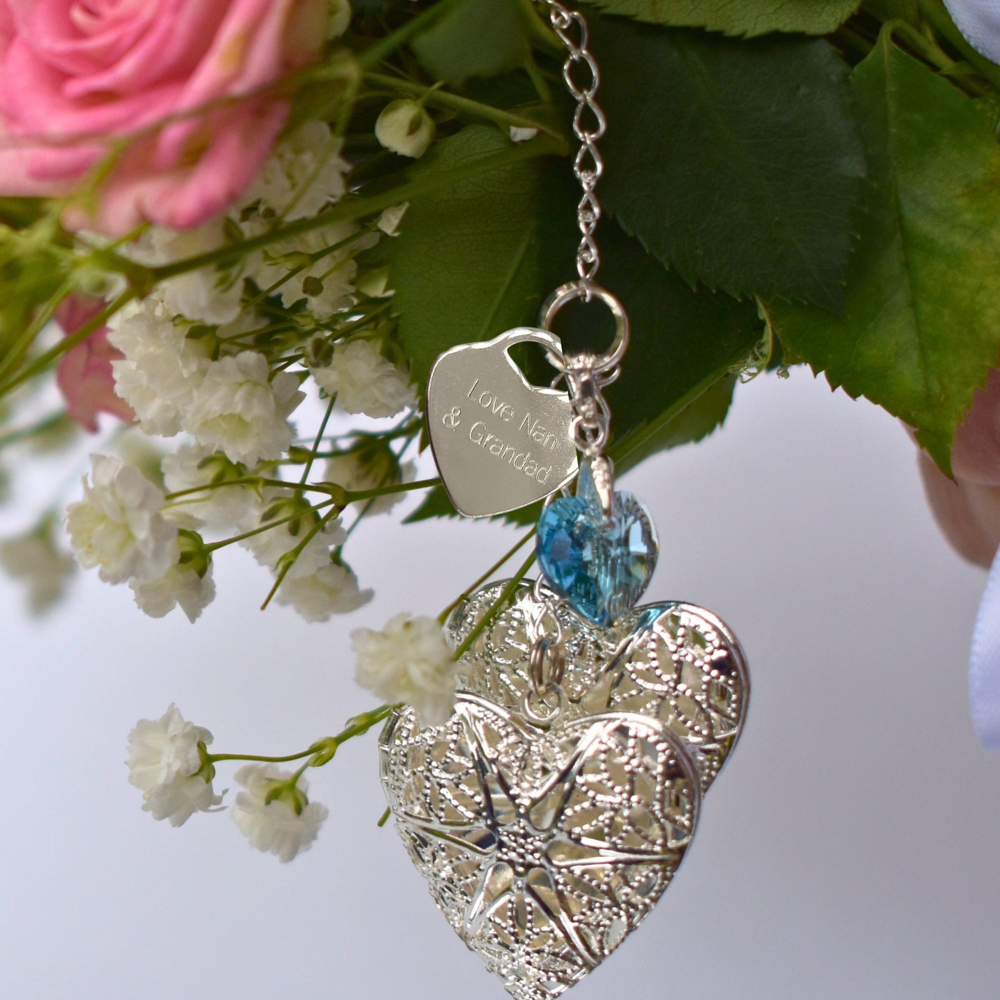 Handmade double wedding bouquet charm. Two filigree lockets are separated by blue crystal heart All the items are secured by sterling silver chain and a lobster clasp. You can choose to add an engraved heart with your own message. 
