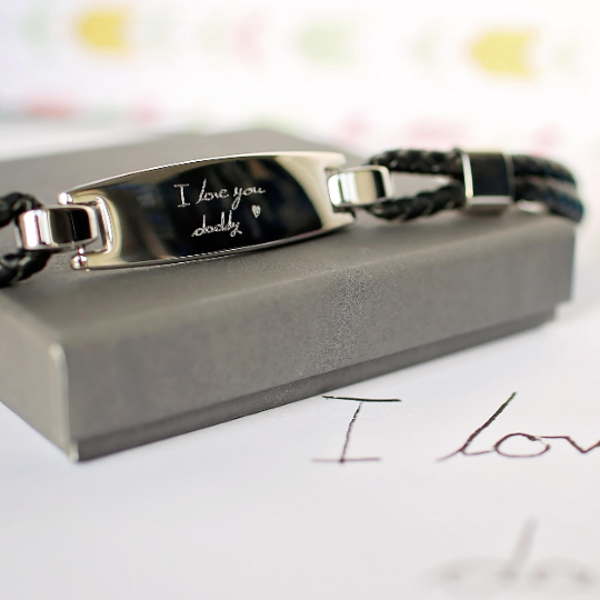 A woven nappa leather strap is looped through a stainless steel plate which is engraved with your own handwriting or special doodle. Fastened with a magnetic clasp and gift boxed.