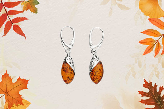 Sterling silver filigree earrings hold a cognac amber drop. Suspended from sterling silver leverback wires