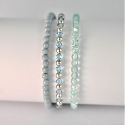 sky blue and silver plated elasticated bead bracelet shown with grey green elasticated bracelet and turquoise glass elasticated bracelet as a stacking set