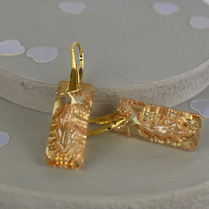 Highest quality Austrian crystal earrings shown in Golden Shadow,. The centre of the crystal is designed to look as if the crystal is still growing and catches the light beaufifully. Suspended from gold plated sterling silver lever back wires and gift boxed