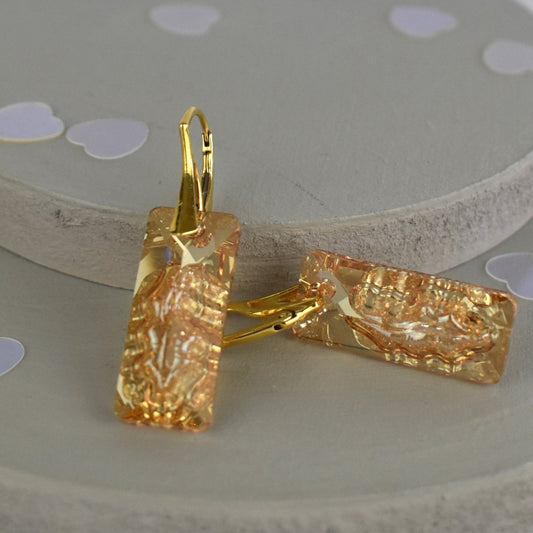 Highest quality Austrian crystal earrings shown in Golden Shadow,. The centre of the crystal is designed to look as if the crystal is still growing and catches the light beaufifully. Suspended from gold plated sterling silver lever back wires and gift boxed