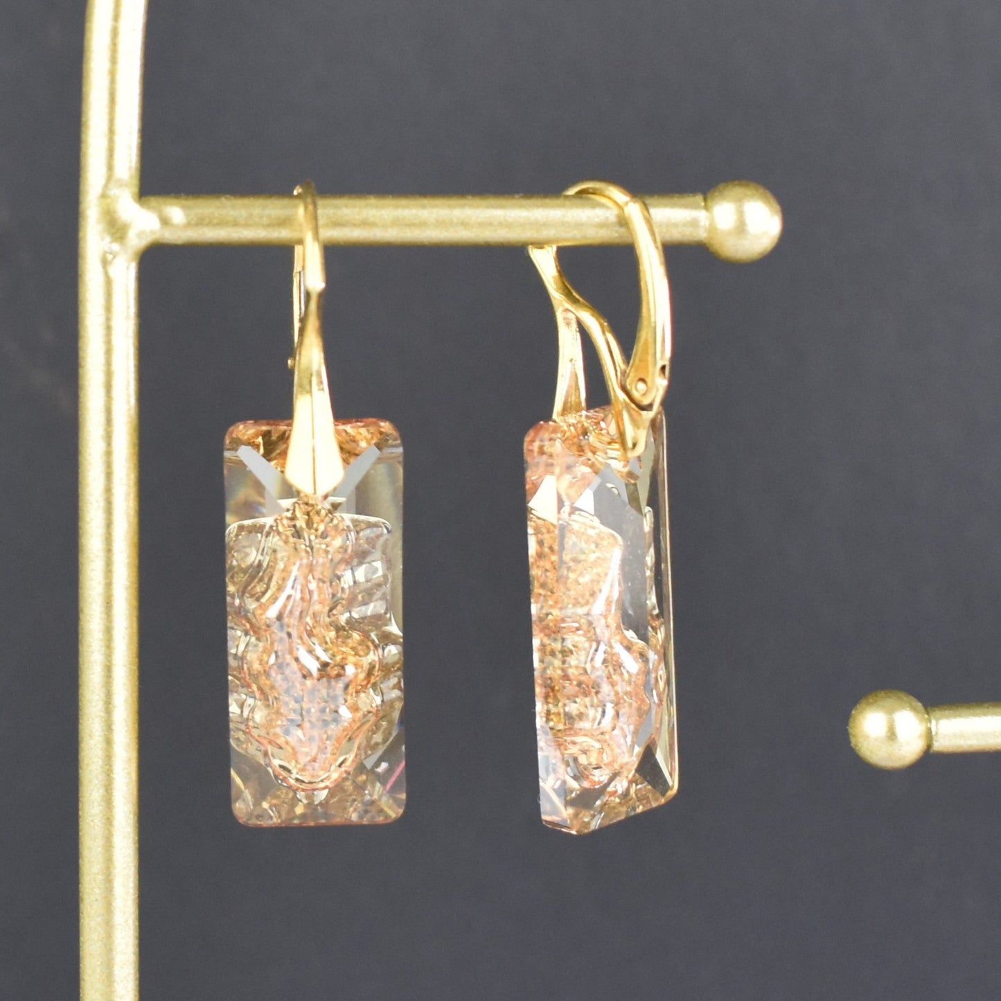 Highest quality Austrian crystal earrings shown in Golden Shadow,. The centre of the crystal is designed to look as if the crystal is still growing and catches the light beaufifully. Suspended from gold plated sterling silver lever back wires and gift boxed