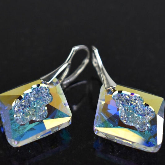 Highest quality crystal earrings with an uneven middle to give the appearance that they are a living crystal, still growing. They reflect light more than other crystals. Mounted on sterling silver lever-back earwires.