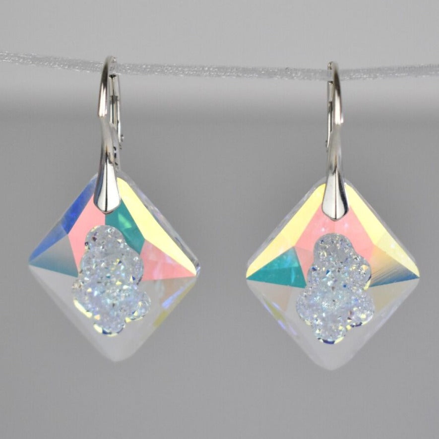 Highest quality crystal earrings with an uneven middle to give the appearance that they are a living crystal, still growing. They reflect light more than other crystals. Mounted on sterling silver lever-back earwires.