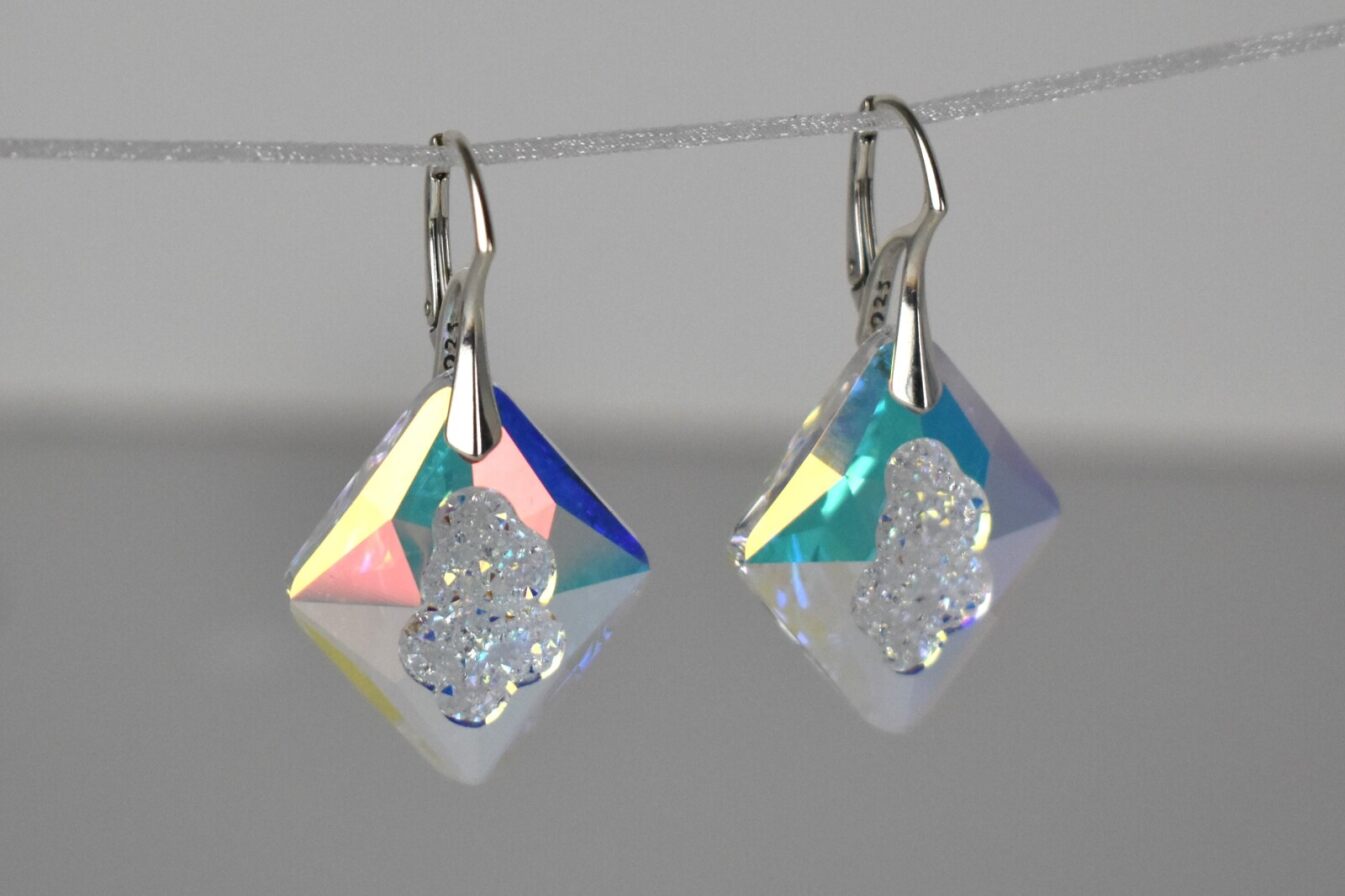 Highest quality crystal earrings with an uneven middle to give the appearance that they are a living crystal, still growing. They reflect light more than other crystals. Mounted on sterling silver lever-back earwires.