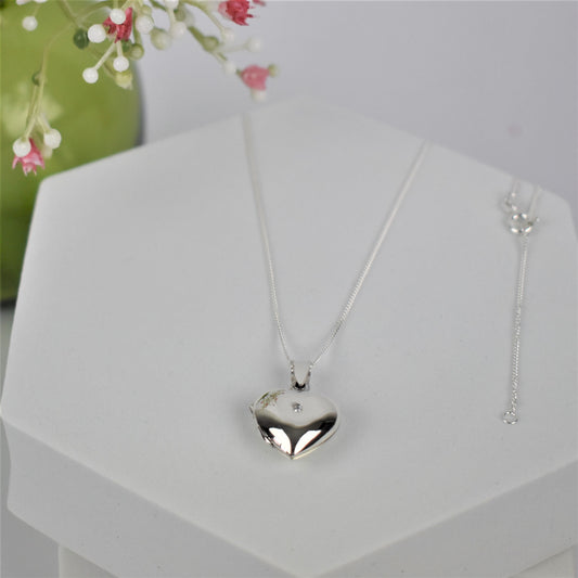 Silver heart-shaped opening locket necklace with a cubic zirconia stone in the centre