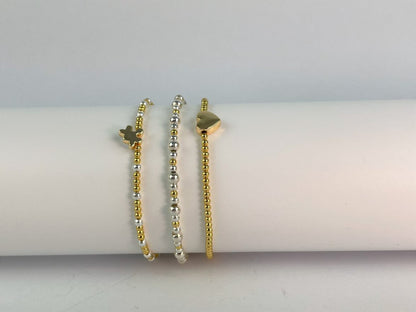 jigsaw bracelet with two colour silver and gold plate beaded elasticated bracelet and gold plated beaded bracelet with heart