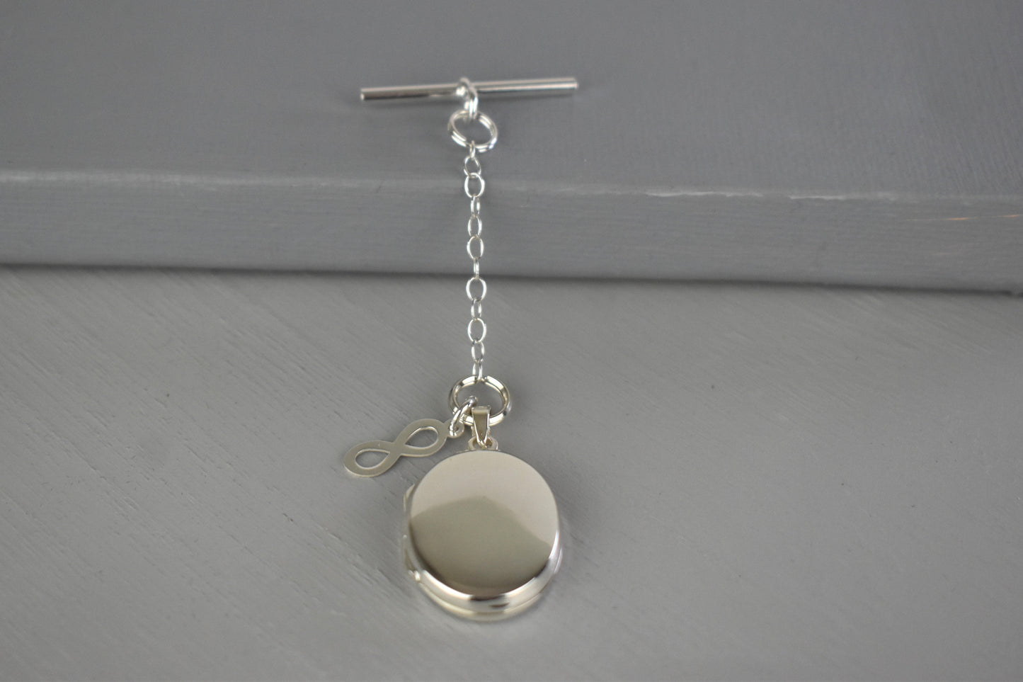Sterling silver photo locket with infinity symbol and clasp