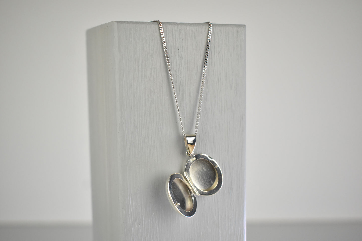 Sterling silver oval locket shown open