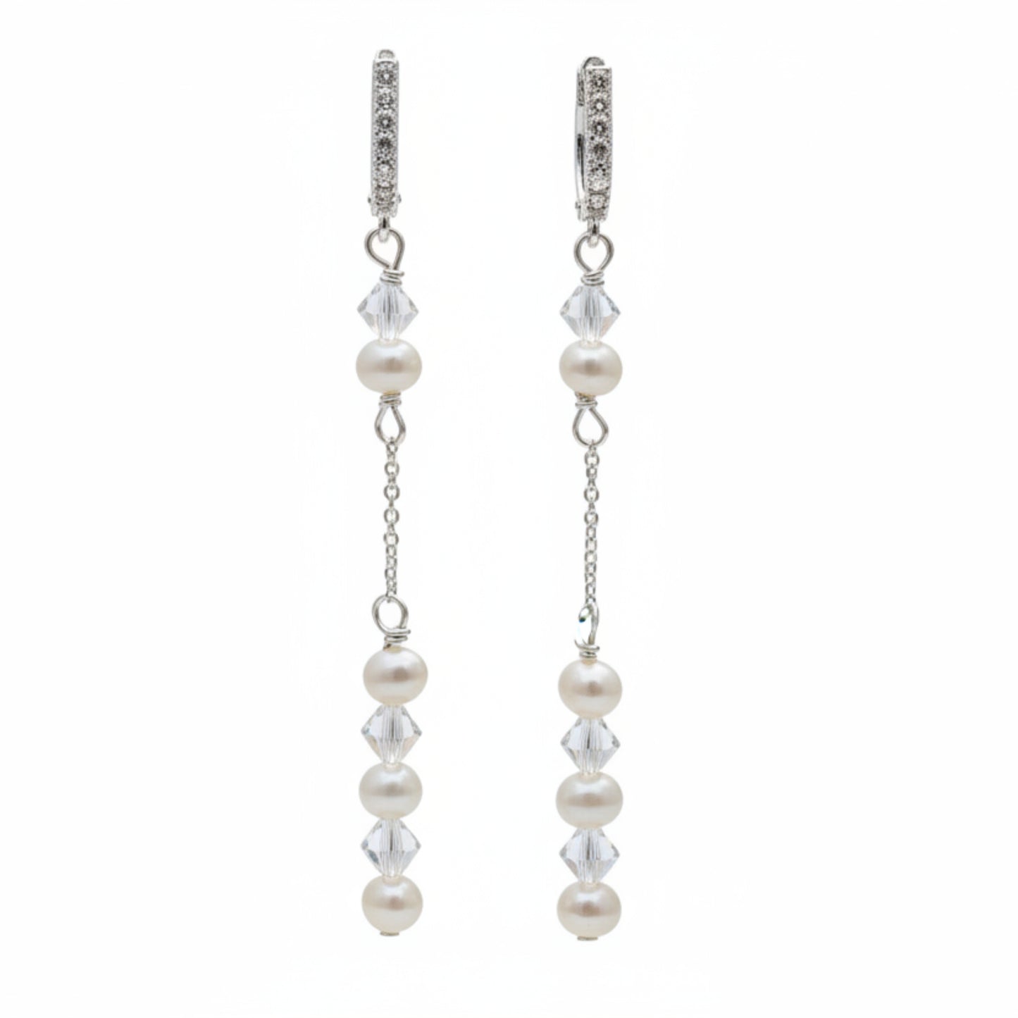 Pearl and crystal earrings using 4mm freshwater pearls and highest quality crystals (also 4mm). The earrings are suspended from sterling silver hoops studded with tiny crystals to reflect the light. 