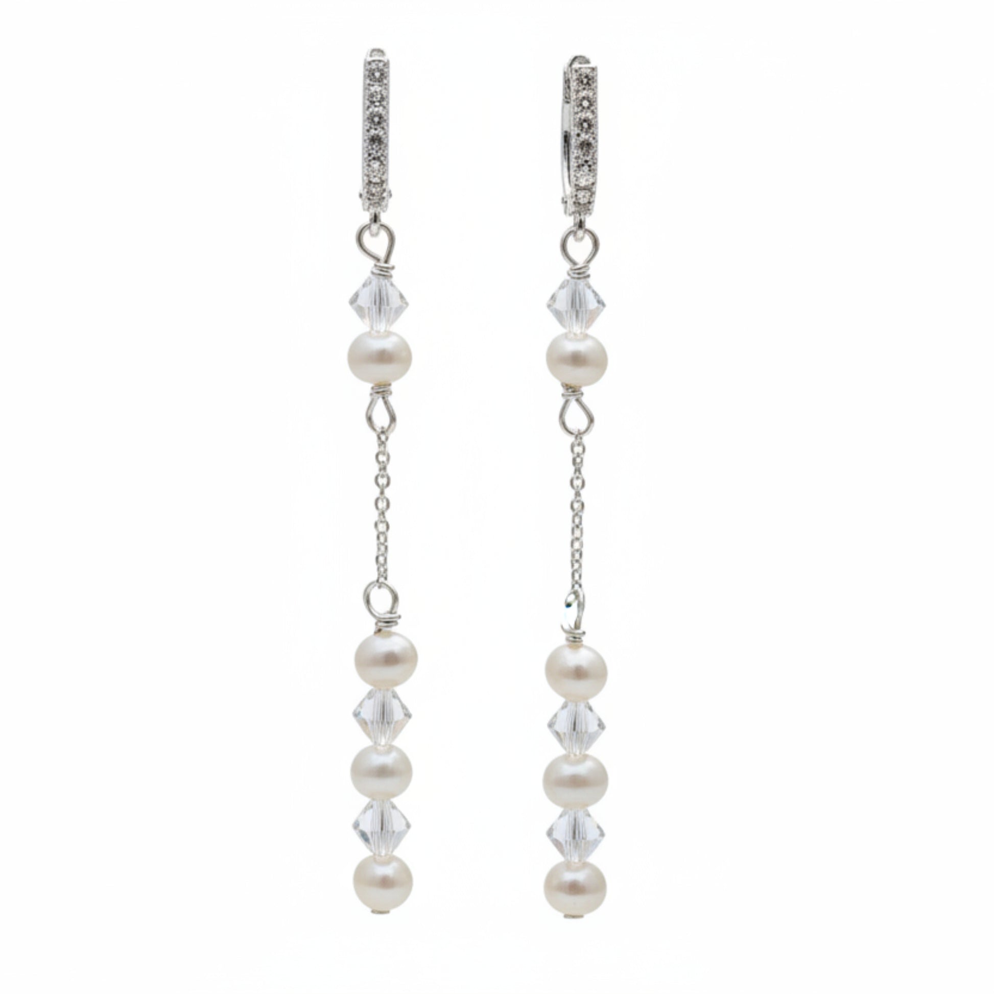 Pearl and crystal earrings using 4mm freshwater pearls and highest quality crystals (also 4mm). The earrings are suspended from sterling silver hoops studded with tiny crystals to reflect the light. 