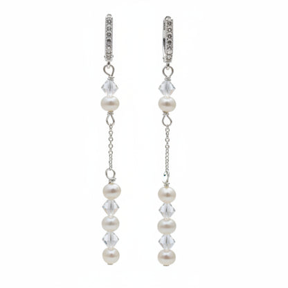 Pearl and crystal earrings using 4mm freshwater pearls and highest quality crystals (also 4mm). The earrings are suspended from sterling silver hoops studded with tiny crystals to reflect the light. 