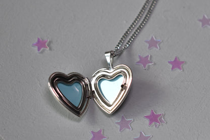 Heart shape locket opens to hold two photographs